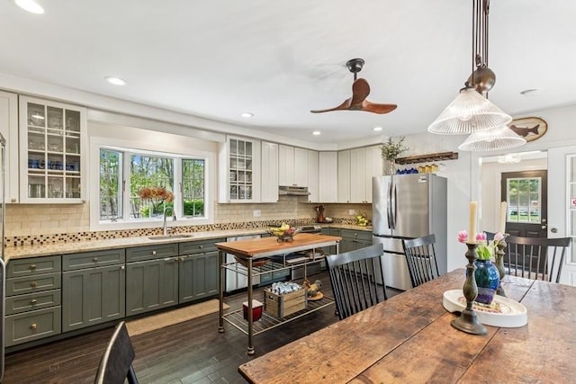 3320 Oregon Rd, Mattituck, NY 11952 - kitchen with freestanding refrigerator, under cabinet range hood, plenty of natural light, backsplash, and recessed lighting
