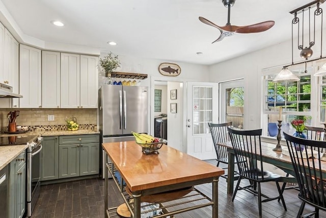 3320 Oregon Rd, Mattituck, NY 11952 - kitchen featuring stainless steel appliances, dark wood-style flooring, under cabinet range hood, a ceiling fan, and backsplash