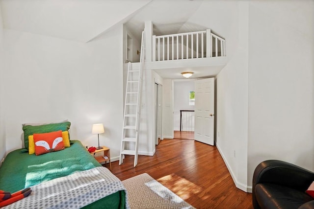 bedroom with baseboards and wood finished floors