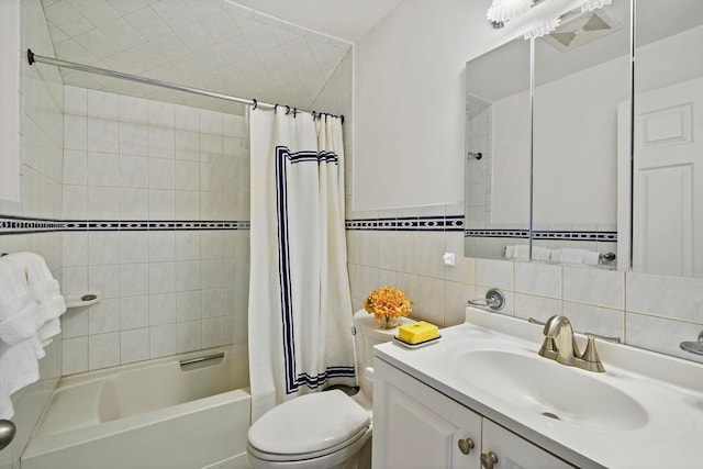 bathroom with toilet, tile walls, shower / bath combination with curtain, and vanity