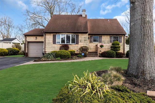 41 Millford Ln, Centereach, NY 11720 - cape cod-style house with a garage, a chimney, roof with shingles, a front yard, and driveway