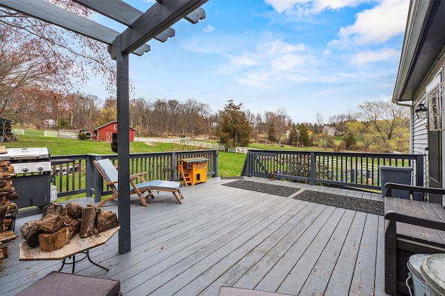 deck featuring an outbuilding, a grill, and a lawn