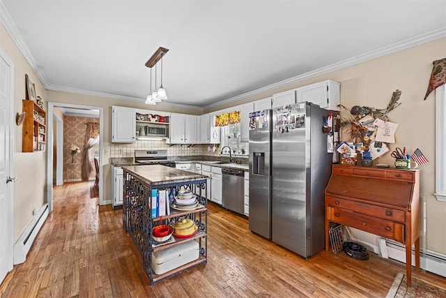 kitchen with open shelves, appliances with stainless steel finishes, wood-type flooring, and a baseboard heating unit