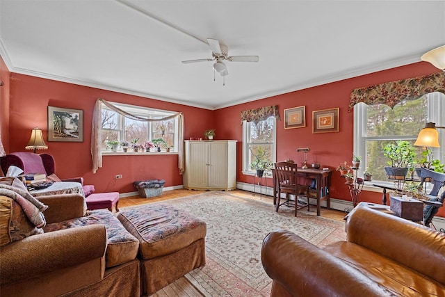 living area with a baseboard radiator, wood finished floors, ornamental molding, and a ceiling fan