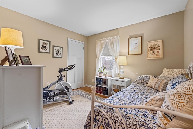 bedroom featuring baseboards and wood finished floors