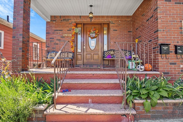 13506 62nd Rd, Flushing, NY 11367 - doorway to property featuring brick siding and a porch