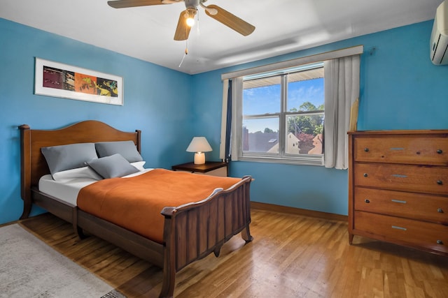 13506 62nd Rd, Flushing, NY 11367 - bedroom with light wood-type flooring, a wall mounted air conditioner, baseboards, and ceiling fan