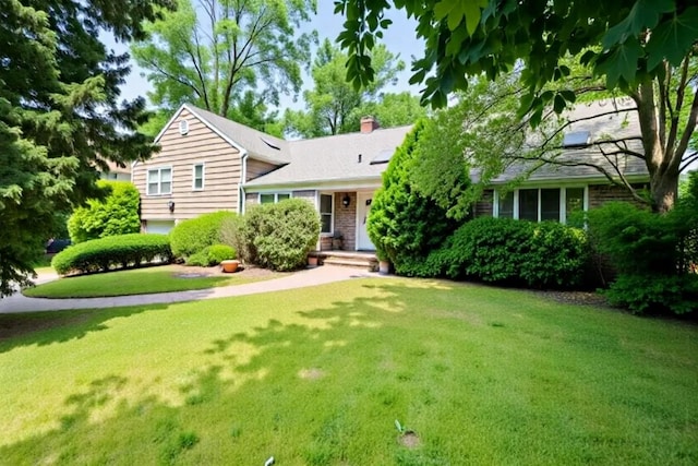 tri-level home with a chimney and a front lawn