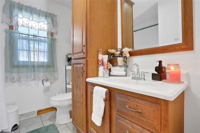 bathroom with visible vents, baseboards, toilet, vanity, and tile patterned flooring