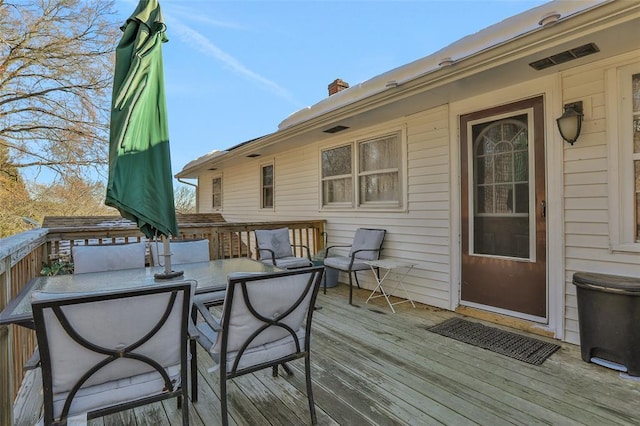 wooden deck with outdoor dining space