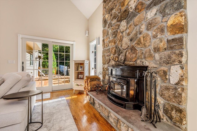 living room with wood finished floors and high vaulted ceiling