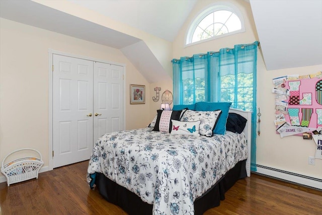 bedroom with a baseboard radiator, wood finished floors, a closet, and vaulted ceiling