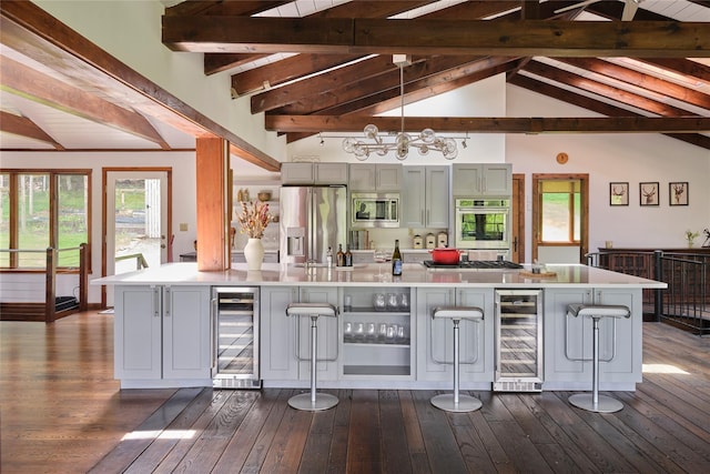 65 Deuner Hill Rd, Callicoon Center, NY 12723 - kitchen with beverage cooler, appliances with stainless steel finishes, a breakfast bar, and dark wood-style floors