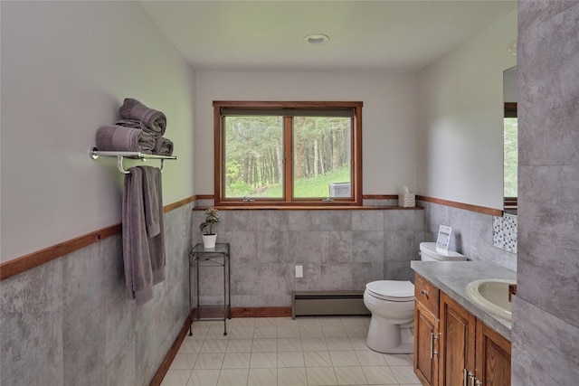 65 Deuner Hill Rd, Callicoon Center, NY 12723 - bathroom with a baseboard heating unit, tile walls, toilet, vanity, and wainscoting