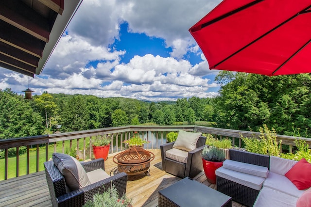 65 Deuner Hill Rd, Callicoon Center, NY 12723 - deck featuring an outdoor living space with a fire pit and a forest view