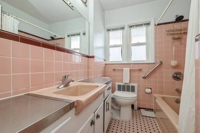260 Washington Ave, Harbor Isle, NY 11558 - bathroom featuring shower / bath combo with shower curtain, tile walls, toilet, and vanity