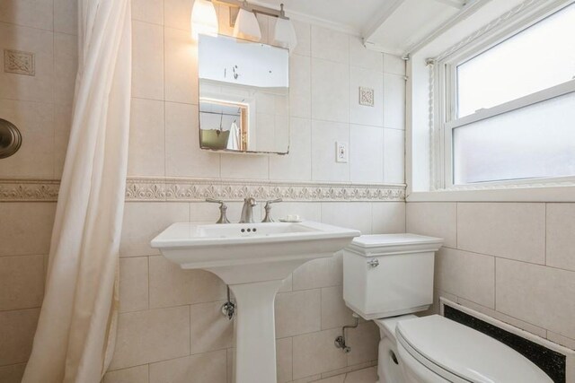 260 Washington Ave, Harbor Isle, NY 11558 - full bath with toilet, ornamental molding, curtained shower, and tile walls