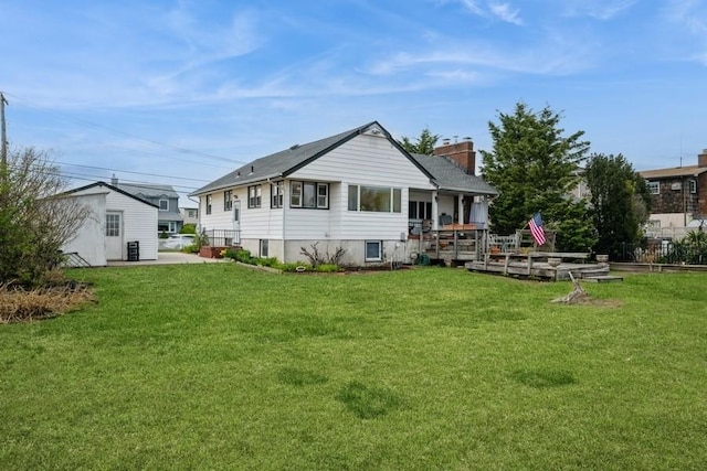 260 Washington Ave, Harbor Isle, NY 11558 - rear view of house featuring a chimney and a yard