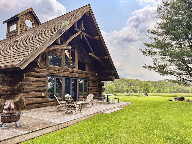 649 County Road 95, North Branch, NY 12766 - rear view of house with a fire pit, a wooden deck, a lawn, and log exterior