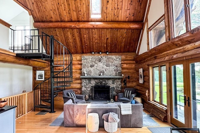 649 County Road 95, North Branch, NY 12766 - living area featuring high vaulted ceiling, rustic walls, a wood ceiling with exposed beams, stairs, and a stone fireplace