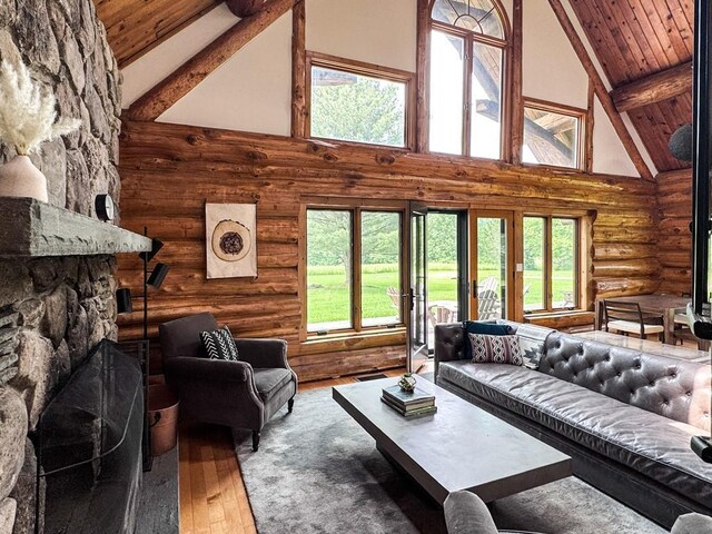 649 County Road 95, North Branch, NY 12766 - living room featuring high vaulted ceiling, log walls, wood-type flooring, healthy amount of natural light, and a wood ceiling with exposed beams