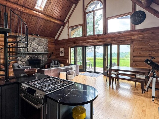 649 County Road 95, North Branch, NY 12766 - living room featuring log walls, high vaulted ceiling, plenty of natural light, light wood-style floors, and a skylight