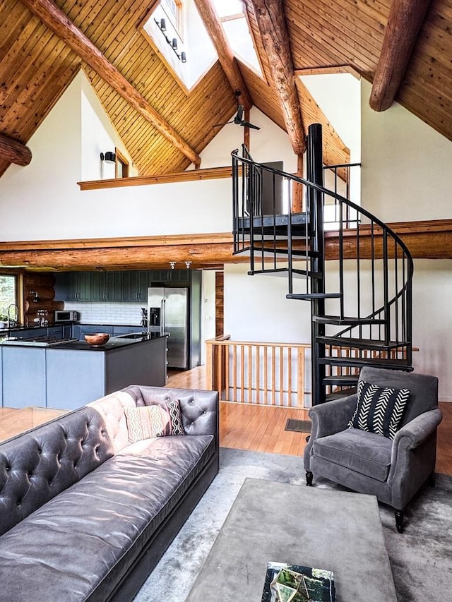 649 County Road 95, North Branch, NY 12766 - living room featuring a skylight, a wooden ceiling with exposed beams, wood finished floors, high vaulted ceiling, and stairway