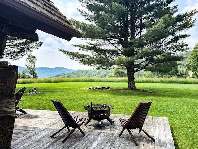 649 County Road 95, North Branch, NY 12766 - wooden deck featuring an outdoor fire pit, a yard, and a mountain view