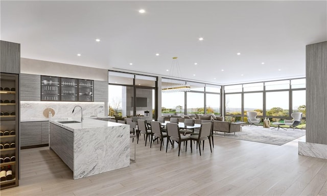 570 Bedford Rd Unit 6-1C, Armonk, NY 10504 - dining area featuring light wood-type flooring, a healthy amount of sunlight, and a wall of windows
