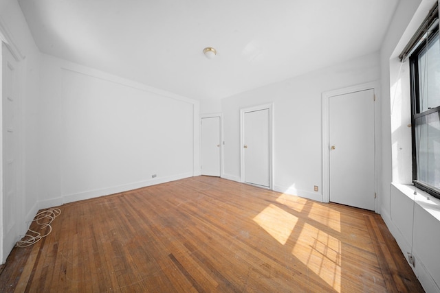 1001 Anderson Ave Unit 22, Bronx, NY 10452 - unfurnished bedroom with wood finished floors, multiple windows, and multiple closets