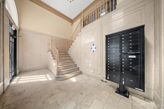 1001 Anderson Ave Unit 22, Bronx, NY 10452 - stairway with mail area, ornamental molding, a decorative wall, and a high ceiling