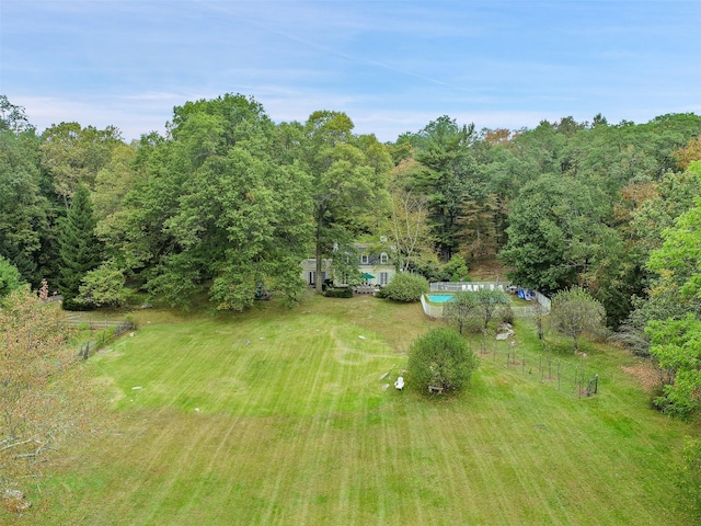 birds eye view of property featuring a wooded view