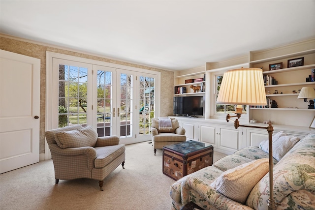 living room featuring light carpet, a healthy amount of sunlight, and french doors