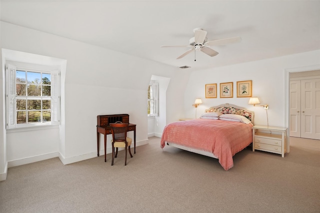 bedroom featuring visible vents, ceiling fan, baseboards, and light colored carpet