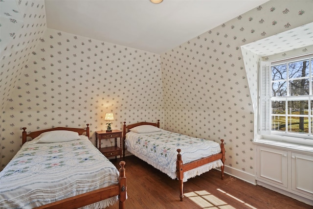 bedroom with wallpapered walls, baseboards, and wood finished floors