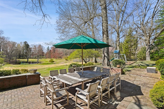 view of patio / terrace with outdoor dining space and a playground