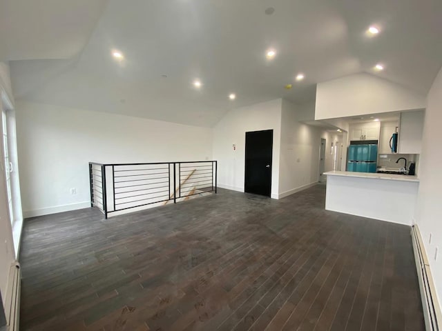 unfurnished living room with vaulted ceiling, recessed lighting, baseboards, dark wood finished floors, and a baseboard radiator