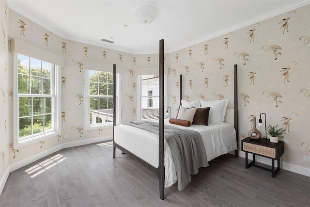bedroom featuring multiple windows, visible vents, crown molding, and wood finished floors