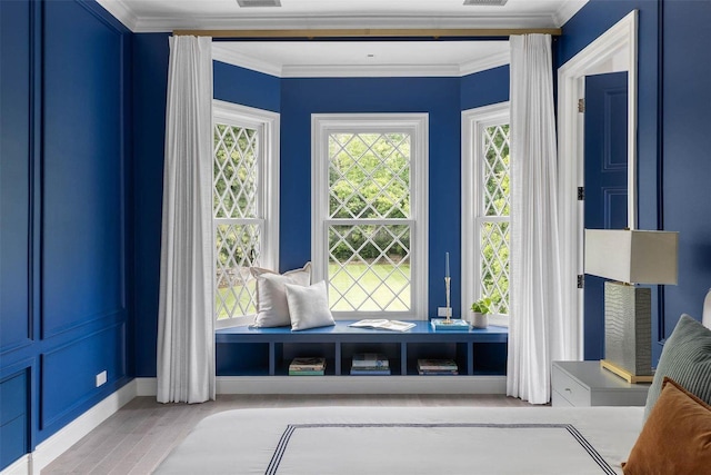 interior space featuring visible vents, crown molding, and light wood-type flooring