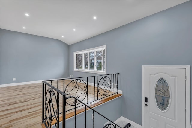 foyer with recessed lighting, baseboards, and wood finished floors