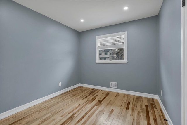 spare room featuring baseboards, visible vents, wood finished floors, and recessed lighting