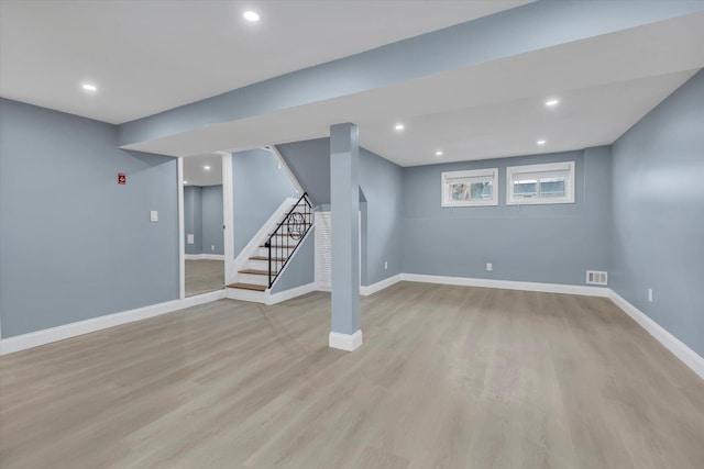 basement featuring stairs, light wood-type flooring, recessed lighting, baseboards, and visible vents