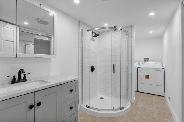 bathroom with recessed lighting, separate washer and dryer, tile patterned floors, and a stall shower