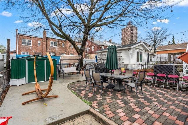 61-27 160th St, Fresh Meadows, NY 11365 - view of patio with an outbuilding, a shed, a fenced backyard, and outdoor dining area