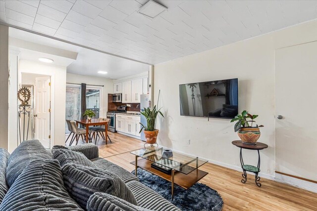 61-27 160th St, Fresh Meadows, NY 11365 - living room featuring baseboards and light wood finished floors