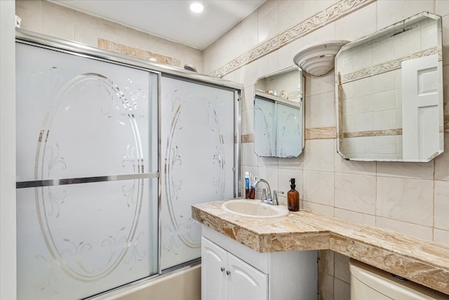 61-27 160th St, Fresh Meadows, NY 11365 - bathroom with combined bath / shower with glass door, vanity, tile walls, and decorative backsplash