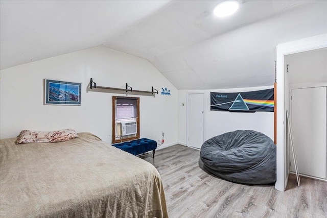61-27 160th St, Fresh Meadows, NY 11365 - bedroom featuring a barn door, lofted ceiling, cooling unit, and wood finished floors