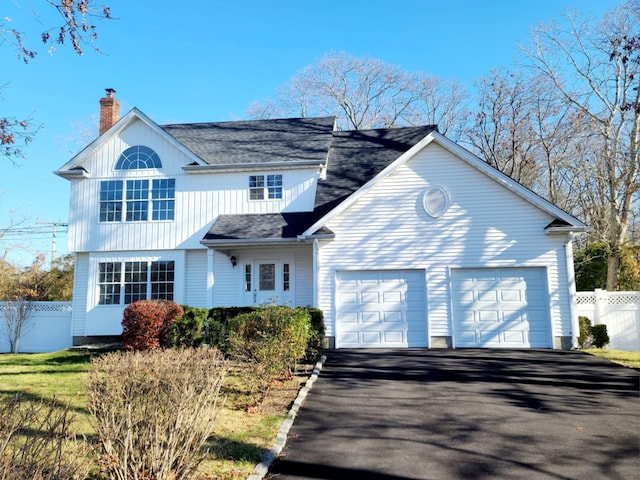 89 Railroad Ave, Center Moriches, NY 11934 - traditional-style house featuring driveway, a garage, fence, and a chimney