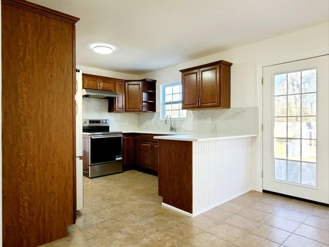 89 Railroad Ave, Center Moriches, NY 11934 - kitchen with light countertops, tasteful backsplash, under cabinet range hood, and stainless steel electric range
