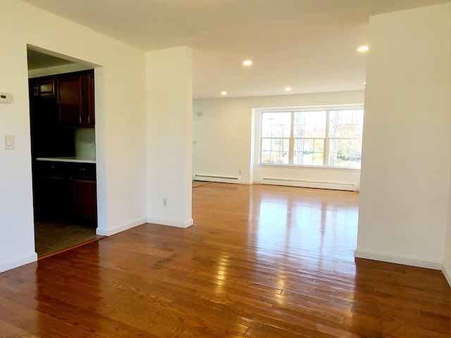 89 Railroad Ave, Center Moriches, NY 11934 - unfurnished room with a baseboard radiator, hardwood / wood-style flooring, baseboards, and recessed lighting